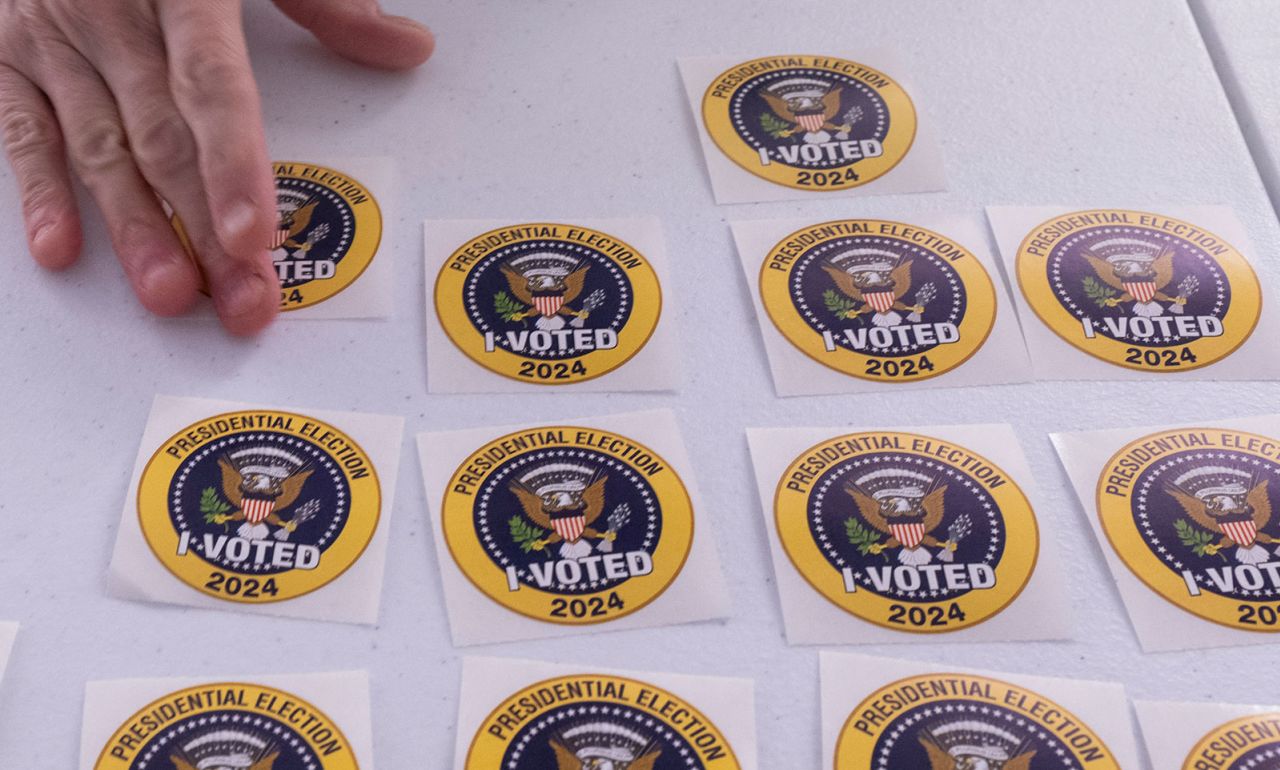 A voter picks up an "I Voted" sticker after casting an early ballot at a polling station in Arlington, Virginia, on September 20.