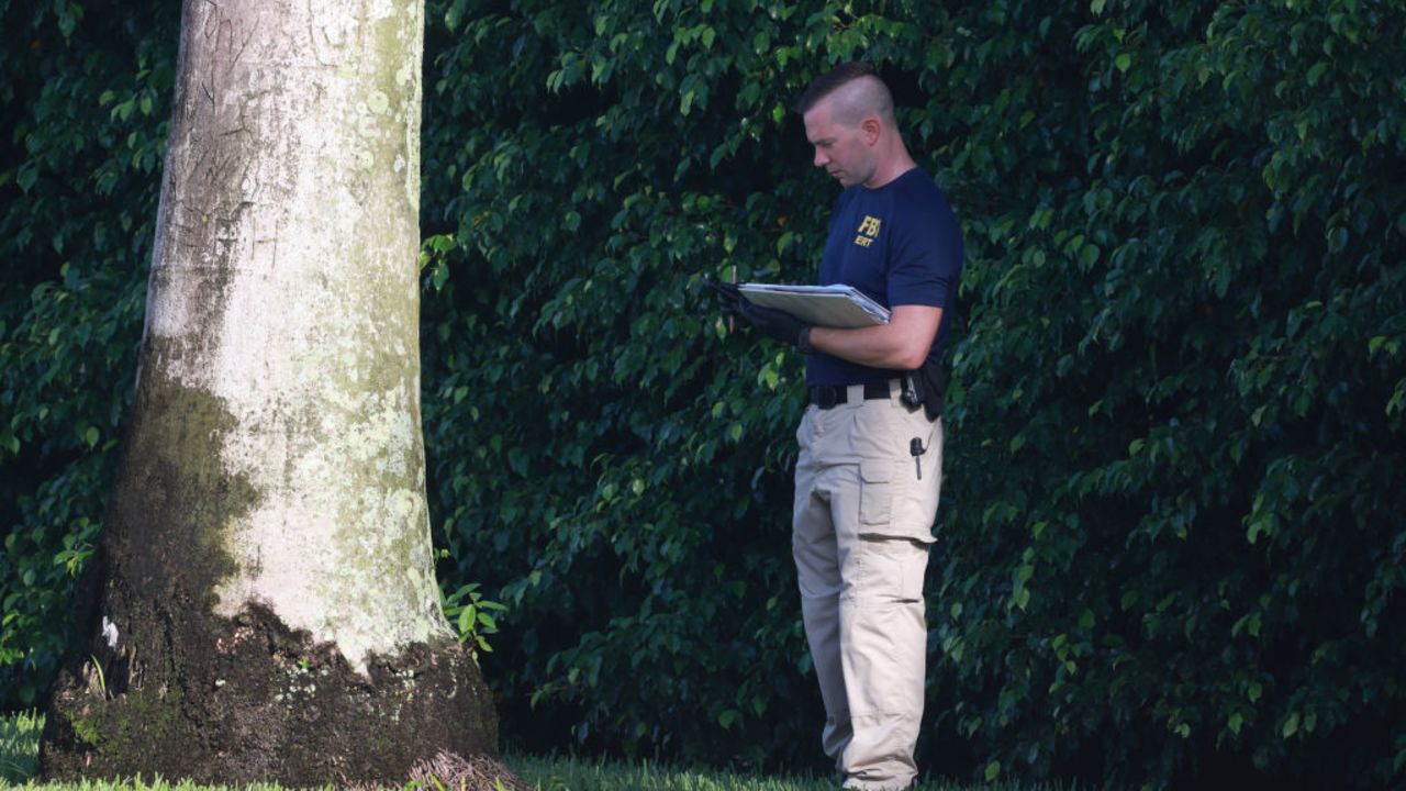 WEST PALM BEACH, FLORIDA - SEPTEMBER 16: A member of the FBI investigates the area around Trump International Golf Club after an apparent assassination attempt on former President Donald Trump on September 16, 2024 in West Palm Beach, Florida. The FBI and U.S. Secret Service, along with the Palm Beach County Sheriff's office, are investigating the incident, which the FBI said "appears to be an attempted assassination of former President Trump" while he was golfing at Trump International Golf Club. (Photo by Joe Raedle/Getty Images)