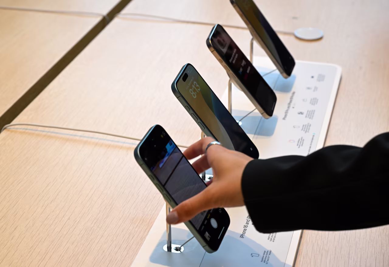 People look at iPhones at the Apple Store in Palo Alto, California in 2024.