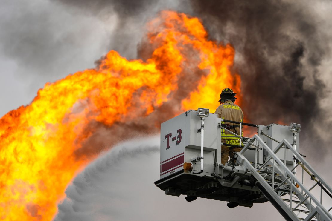 LA PORTE, TEXAS - SEPTEMBER 16: A firefighter directs a line of water around a fire on a pipeline carrying liquified natural gas near Spencer Highway and Summerton on Monday, Sept. 16, 2024 in La Porte. The fire caused road closures and shelter-in-place advisories Monday afternoon in the area, with evacuations to homes and businesses within a half mile from the fire site. (Brett Coomer/Houston Chronicle via Getty Images)