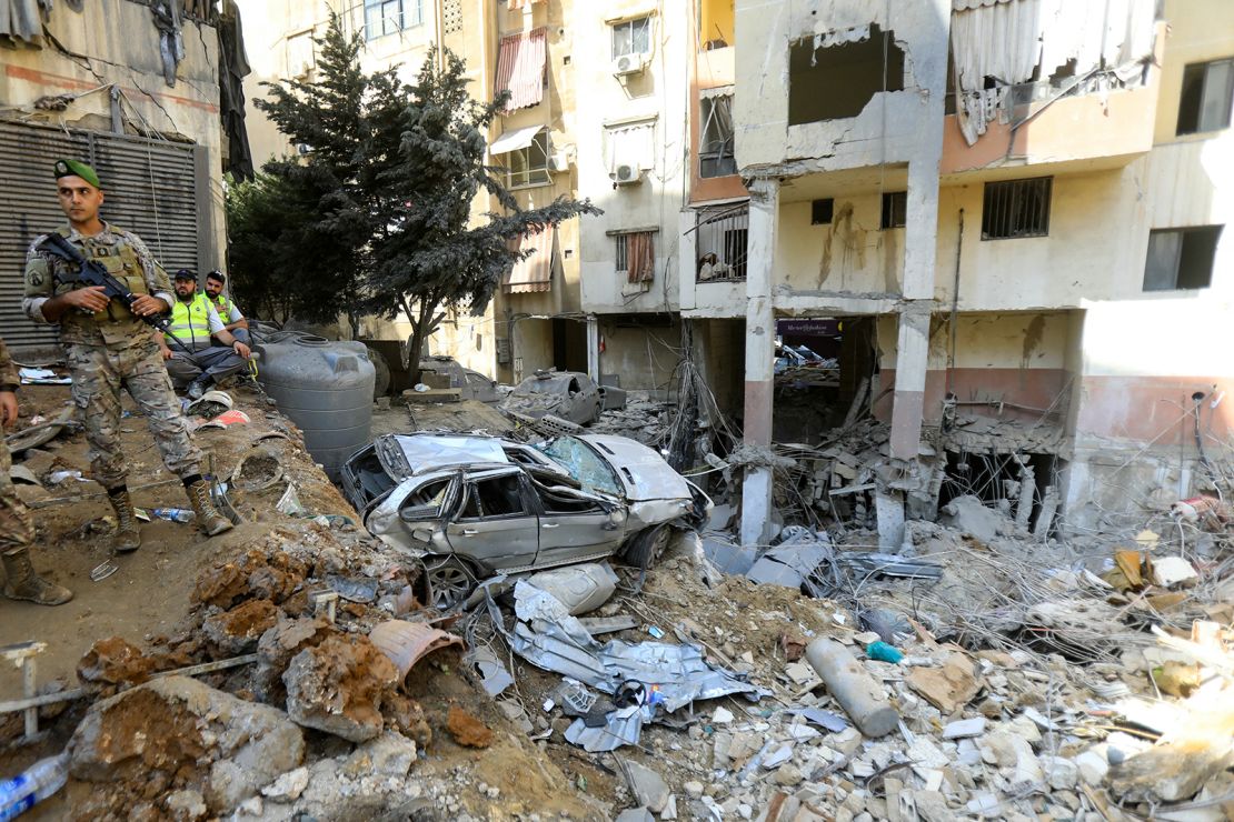 A Lebanese army soldier stands guard at the scene of an Israeli attack that targeted Beirut's southern suburbs a day earlier, as search and rescue operations continue, on September 21, 2024.