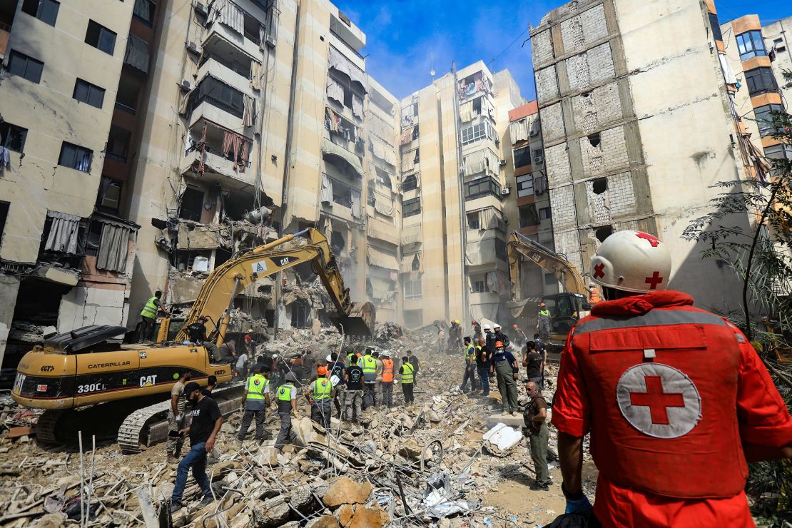 Rescuers sift through the rubble at the scene of an Israeli strike that targeted Beirut's southern suburbs a day earlier, as search and rescue operations continue on September 21.