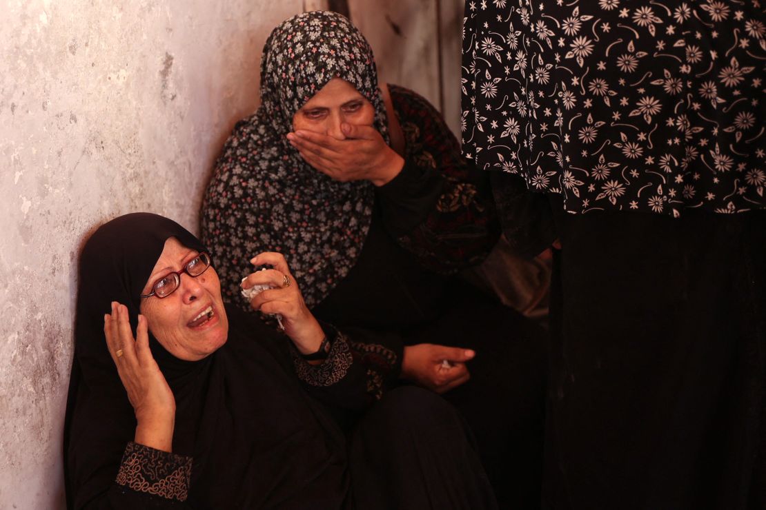 Palestinians mourn over bodies of relatives.