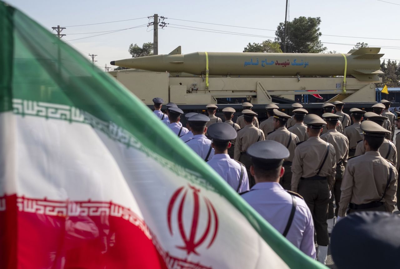 An Iran-made missile is carried past an Iranian flag during a military parade in Tehran on September 21.