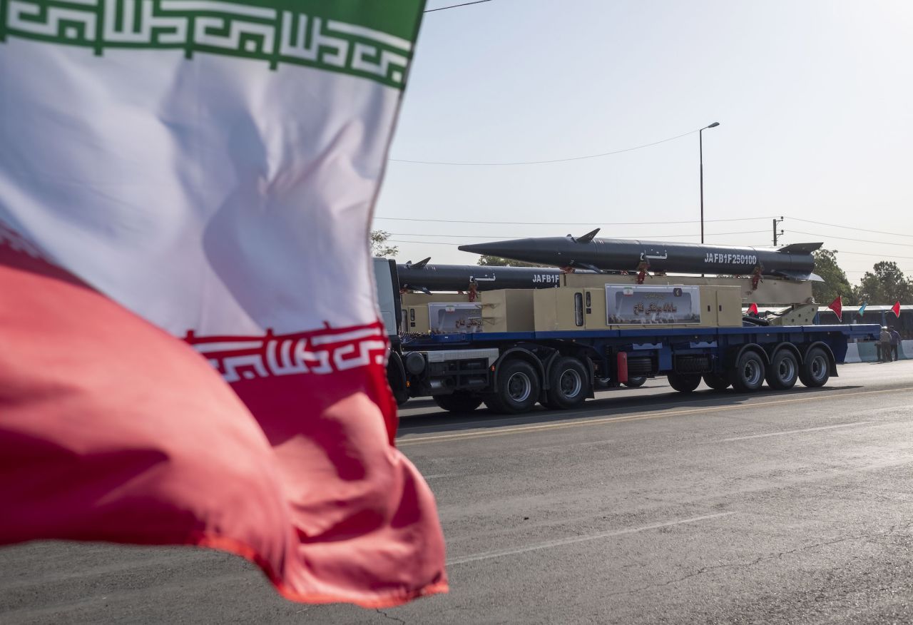 Iran's Fattah hypersonic missile is carried past an Iranian flag during a military parade in the south of Tehran, Iran, on September 21.