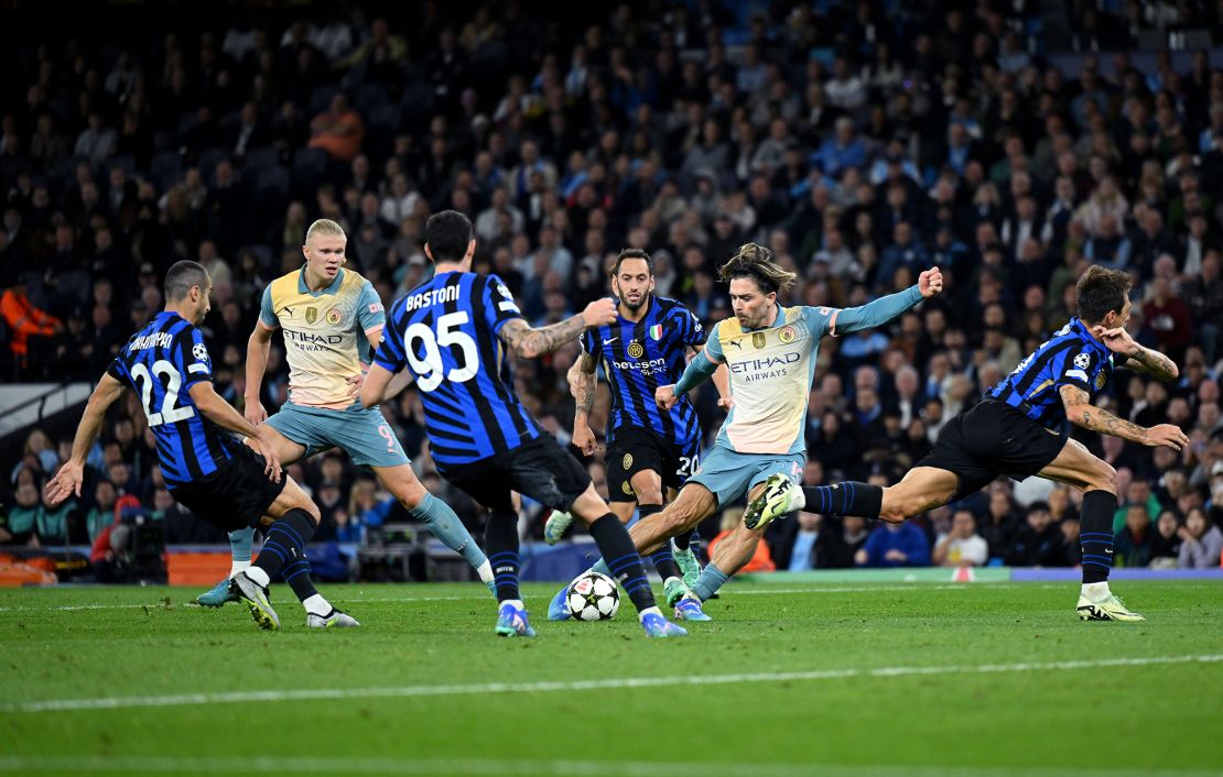 Manchester City's Jack Grealish shoots under pressure from the Inter defense.