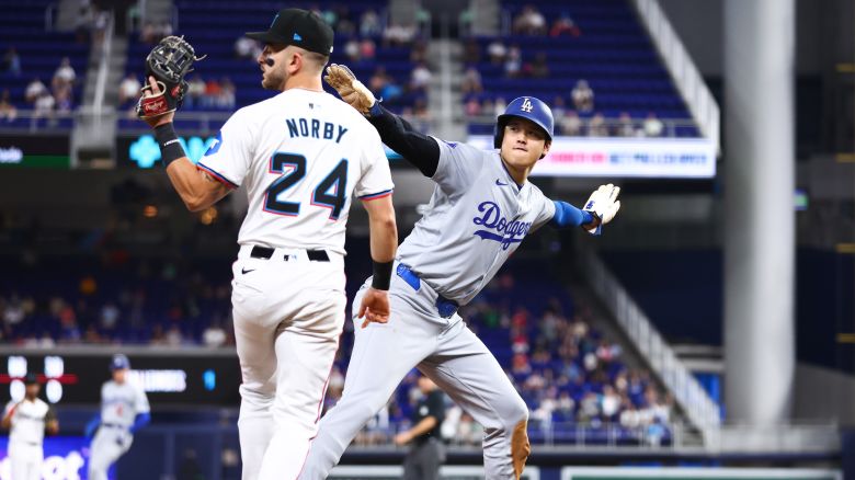 MIAMI, FLORIDA - SEPTEMBER 19: Shohei Ohtani #17 of the Los Angeles Dodgers reacts after stealing third base ahead of Connor Norby #24 of the Miami Marlins to register his 50th stolen base of the season against the Miami Marlins during the first inning of the game at loanDepot park on September 19, 2024 in Miami, Florida. (Photo by Megan Briggs/Getty Images)