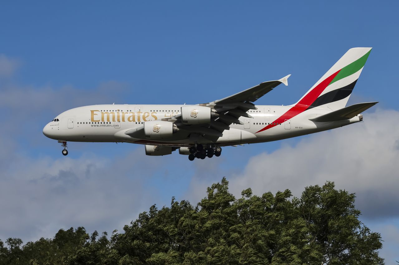 Emirates Airbus A380 double decker passenger aircraft spotted flying in the air between the blue sky and the clouds, on final approach for landing on the runway of London Heathrow Airport LHR in the United Kingdom. The superjumbo wide body airplane has the registration tail number A6-EUI and is powered by 4x Engine Alliance EA GP7270 jet engines. The long haul airliner is arriving from Dubai. Emirates EK is one of the flag carrier airline in the United Arab Emirates UAE owned by the Government of Dubai Investment Corporation of Dubai. The airline is the 4th largest in the world with main hub Dubai International Airport DXB, with a fleet of 249 planes. London, UK on September 2024 (Photo by Nicolas Economou/NurPhoto via Getty Images)