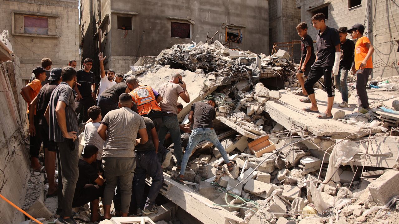 Palestinians search for survivors amids the rubble of a building, which collapsed after Israeli bombardment on a building adjacent to it, in the Sheikh Radwan neighbourhood in Gaza City on September 23, 2024, amid the ongoing war between Israel and the militant Hamas group.