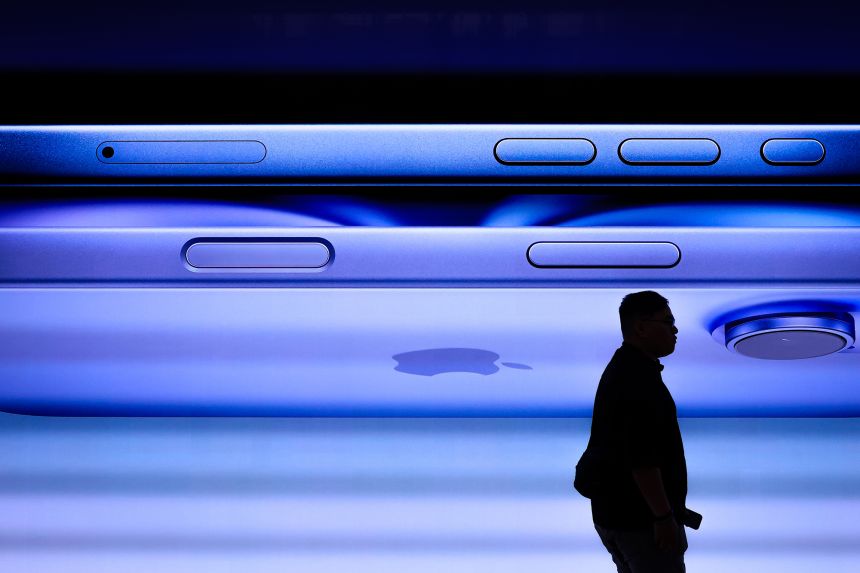 A man walks past a screen displaying the iPhone 16 inside the Apple Inc. store at Tun Razak Exchange (TRX) on September 20, 2024, in Kuala Lumpur, Malaysia.