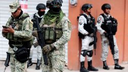 Mexican army soldiers stand guard in the area where members of the collective "Guerreros Buscadores" work in the search for their missing relatives in a clandestine grave in which so far 6 bags with human remains have been found in Zapopan, Jalisco State, Mexico, on September 24, 2024. Jalisco State has the highest number of missing persons in Mexico. (Photo by ULISES RUIZ / AFP) (Photo by ULISES RUIZ/AFP via Getty Images)