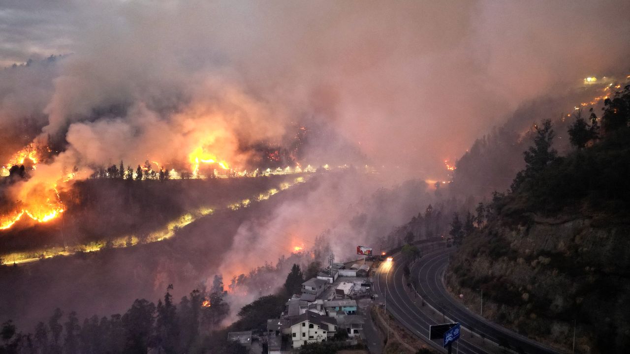 TOPSHOT - Aerial view of a bushfire on a hill in Quito on September 24, 2024. Quito is on a "critical" situation due to five forest fires allegedly arson, forcing preventive evacuation of some 100 families, authorities reported September 24. (Photo by Galo Paguay / AFP) (Photo by GALO PAGUAY/AFP via Getty Images)