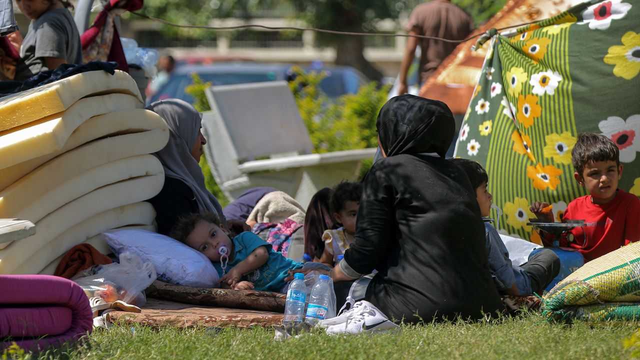 A Syrian refugee family that fled the southern Lebanese city of Nabatiyeh, take sanctuary in a public garden at the southern port city of Sidon, Lebanon, on September 25.