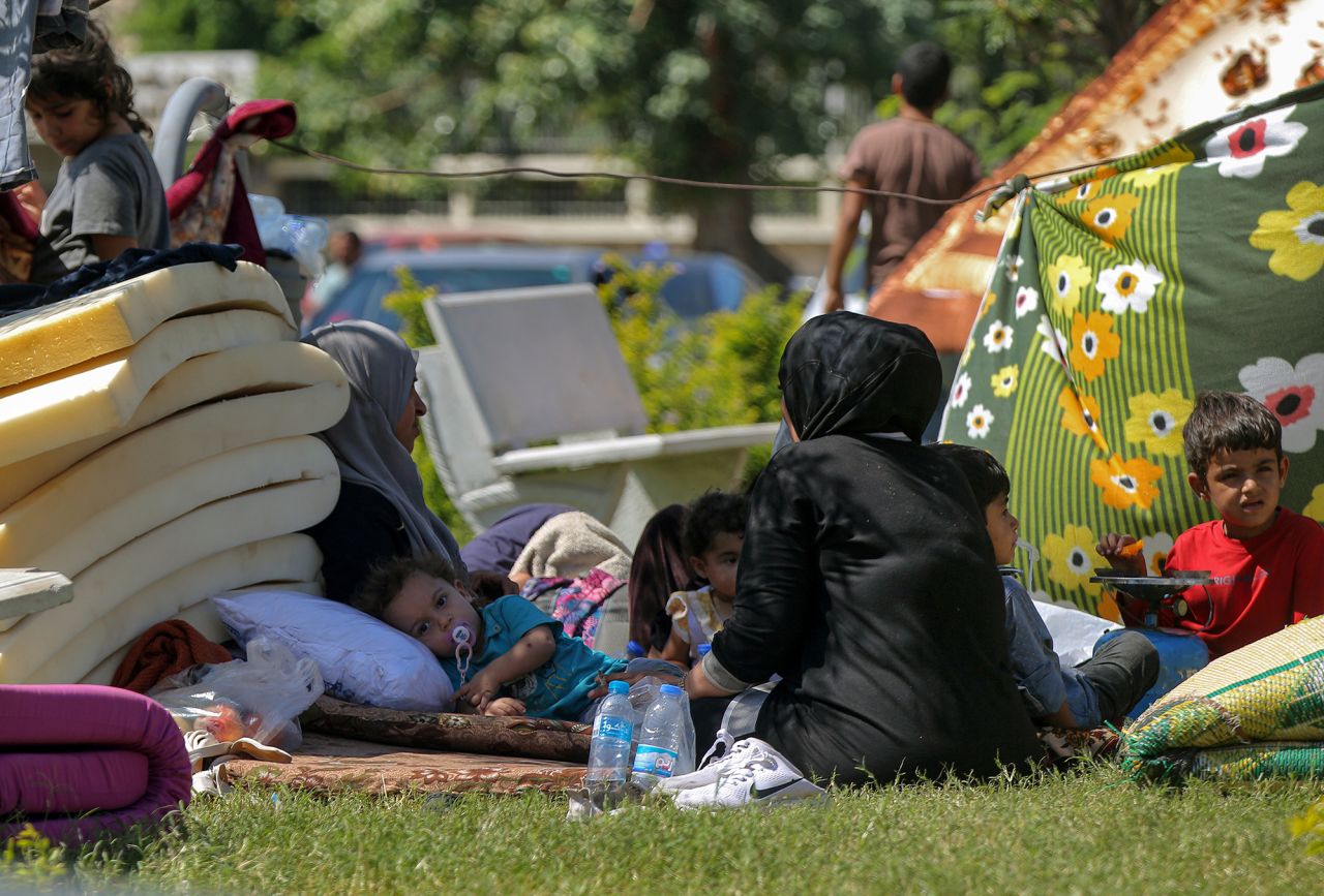 A Syrian refugee family that fled the southern Lebanese city of Nabatiyeh, take sanctuary in a public garden at the southern port city of Sidon, Lebanon, on September 25.