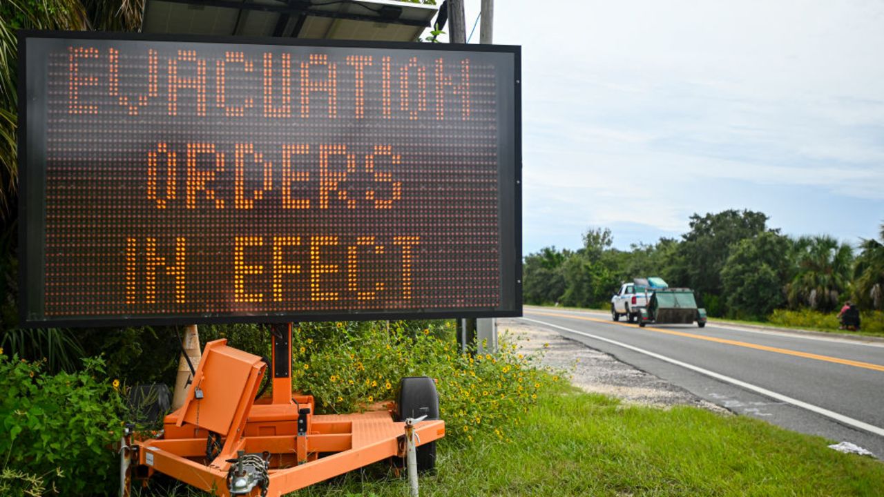 A sign displays evacuation orders as preparations are made for the arrival of Hurricane Helene, in Cedar Key, Florida on September 25, 2024. Thousands of residents on Wednesday began evacuating parts of coastal Florida as the US state braces for Hurricane Helene, forecast to barrel ashore as a powerful, potentially deadly storm. Helene strengthened into a hurricane mid-morning in the Gulf of Mexico and is "expected to bring life-threatening storm surge, damaging winds, and flooding rains to a large portion of Florida and the Southeastern United States," the National Hurricane Center in Miami said in its latest bulletin. (Photo by Miguel J. Rodriguez Carrillo / AFP) (Photo by MIGUEL J. RODRIGUEZ CARRILLO/AFP via Getty Images)