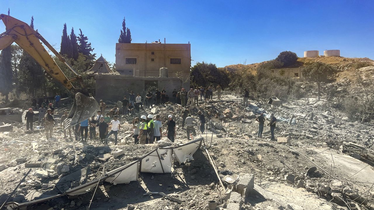 People check the rubble of destroyed buildings in Lebanon's Bekaa Valley village of Younine, on September 26.