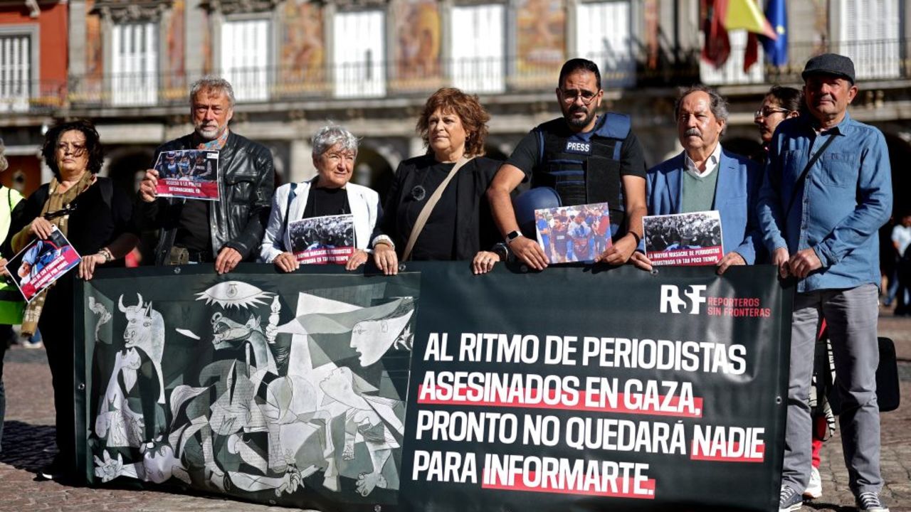 Spanish journalists and Reporters Without Borders (RSF) militants pose holding a banner reading "At the rate of journalists being killed in Gaza, soon there will be no one left to inform you" to denounce the killing of Palestinian journalists in the Gaza Strip, at the Plaza Mayor in Madrid on September 26, 2024. (Photo by Thomas COEX / AFP) (Photo by THOMAS COEX/AFP via Getty Images)