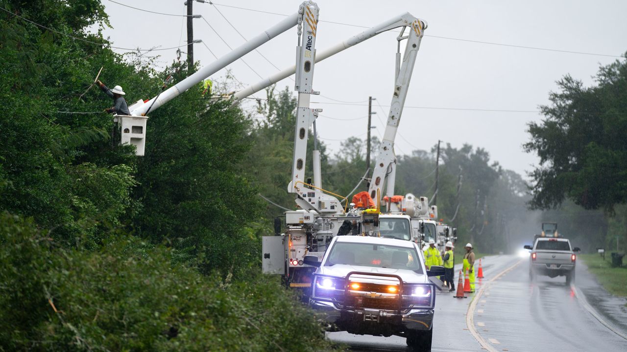 Utility crews repair a line damaged by an outer band of Hurricane Helene on Thursday near Crawfordville, Florida.