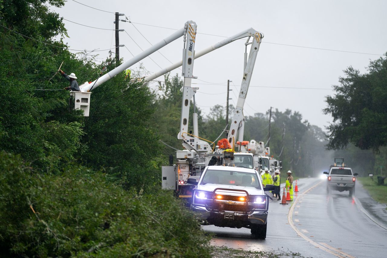 Utility crews repair a line damaged by an outer band of Hurricane Helene on Thursday near Crawfordville, Florida.