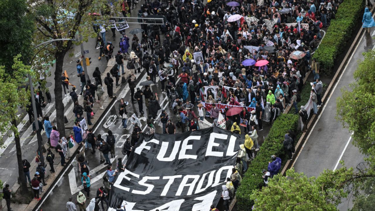 TOPSHOT - People march during a demonstration demanding justice in the case of the Ayotzinapa missing students, in Mexico City, on September 26, 2024, within the 10th anniversary commemoration of the forced disappearance of 43 students from the Ayotzinapa Rural Normal School. (Photo by Yuri CORTEZ / AFP) (Photo by YURI CORTEZ/AFP via Getty Images)