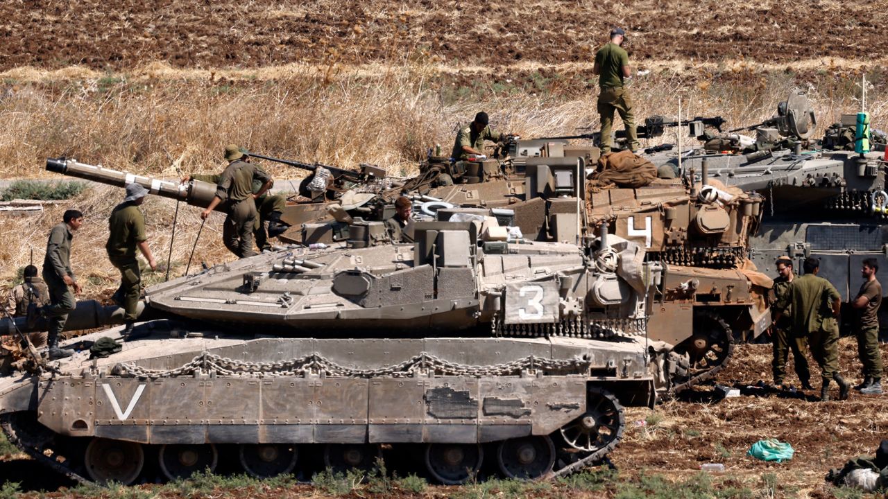 Israeli troops gather in northern Israel on Friday.