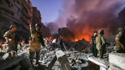 topshot - lebanese army soldiers gather over the rubble of a levelled buildings as people flight the flames, following israeli air strikes in the haret hreik neighbourhood of beirut's southern suburbs on september 27, 2024. a source close to hezbollah said the massive israeli strikes on beirut's southern suburbs flattened six buildings. (photo by ibrahim amro / afp) (photo by ibrahim amro/afp via getty images)