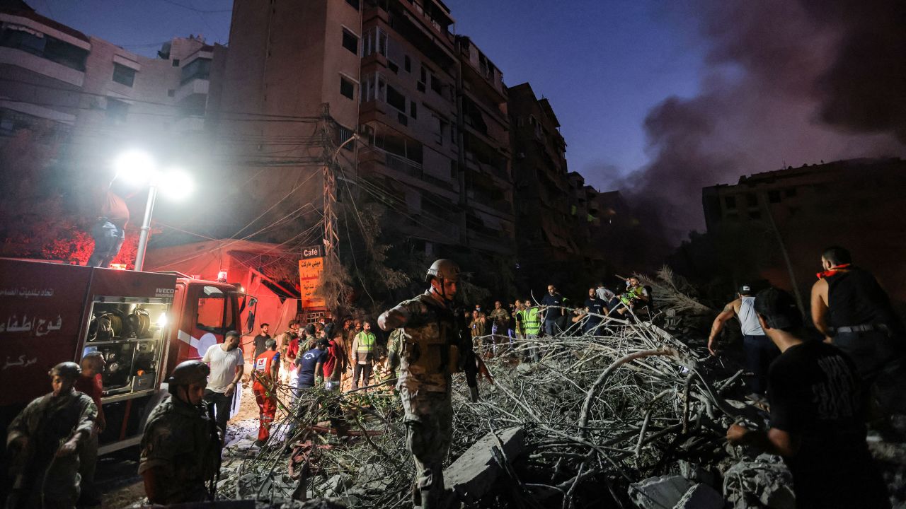 Lebanese soldiers walk over the rubble of leveled buildings following Israeli airstrikes in the southern suburbs of Beirut.