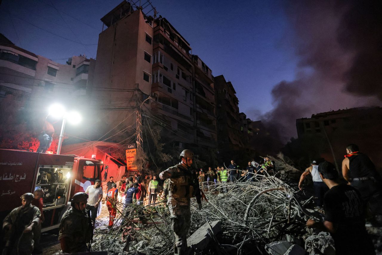 Lebanese soldiers walk over the rubble of leveled buildings following Israeli airstrikes in the southern suburbs of Beirut.