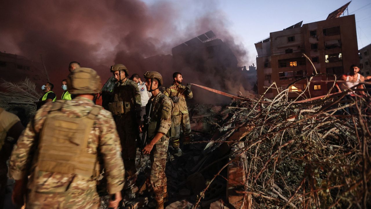 Lebanese army soldiers and emergency personnel work at the scene of an Israeli strike in Beirut's southern suburbs on Friday, September 27.