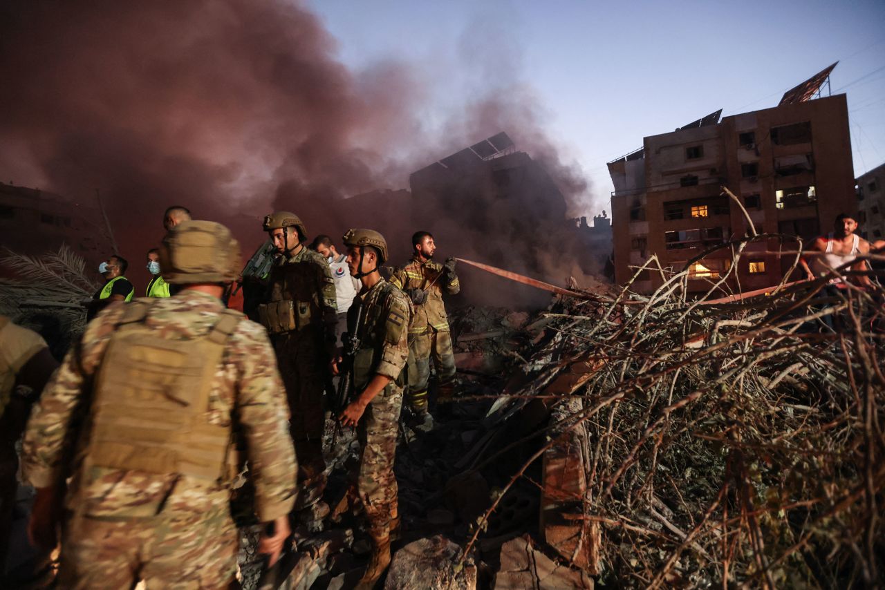 Lebanese army soldiers and emergency personnel work at the scene of an Israeli strike in Beirut's southern suburbs on Friday, September 27.