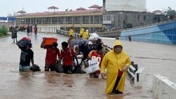 TOPSHOT - People walk on a flooded street heading to a shelter following Hurricane John in Acapulco, Guerrero State, Mexico, on September 27, 2024. Mexican troops scrambled Friday to help victims of a hurricane that battered the Pacific coast, including the beach resort of Acapulco, which is still recovering from a devastating storm last year. (Photo by Francisco ROBLES / AFP) (Photo by FRANCISCO ROBLES/AFP via Getty Images)