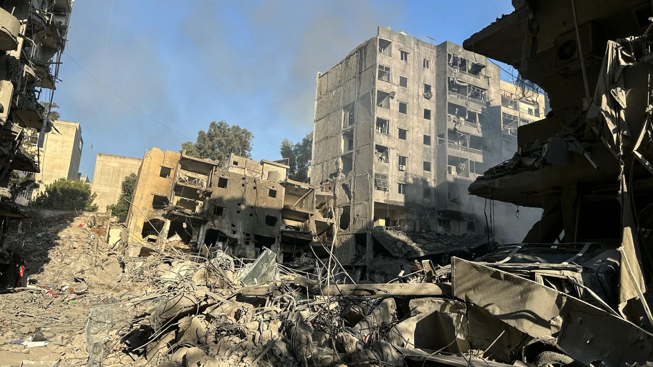 Smoke rises behind buildings destroyed by Israeli airstrikes in Beirut's southern suburbs on September 28.