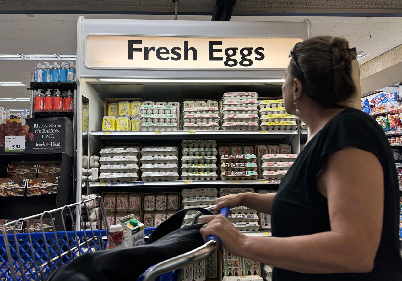 A customer walks by a display of fresh eggs at a grocery store on September 25 in San Anselmo, California.