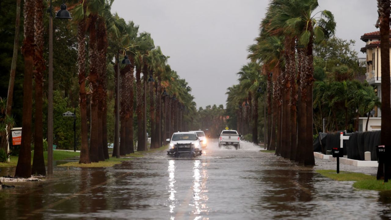 ST. PETE BEACH, FLORIDA - SEPTEMBER 26: Vehicles drive along a flooded street as Hurricane Helene churns offshore on September 26, 2024 in St. Pete Beach, Florida. Later today, Helene is forecast to become a major hurricane, bringing the potential for deadly storm surges, flooding rain, and destructive hurricane-force winds along parts of the Florida West Coast. (Photo by Joe Raedle/Getty Images)