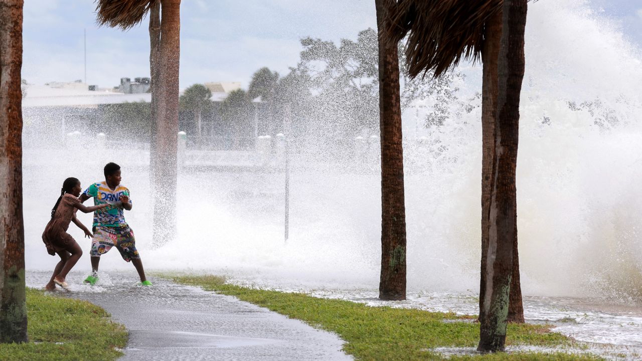 People are splashed by surf from Tampa Bay as Hurricane Helene passes offshore in St. Petersburg, Florida, on September 26.