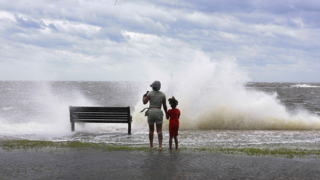 Jamika Bowens and James Womack watch the waves break in St. Petersburg, Florida, on September 26.