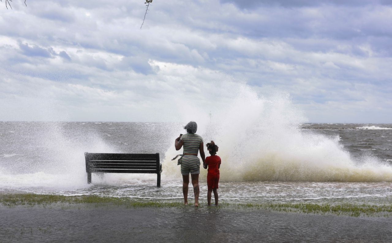 Jamika Bowens and James Womack watch the waves break in St. Petersburg, Florida, on September 26.