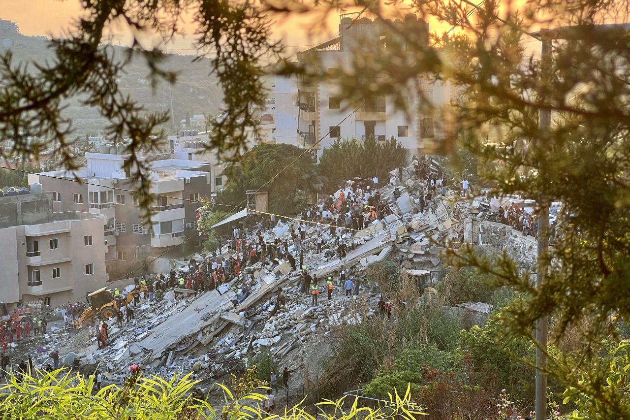 First responders inspect the rubble of a building after it was targeted by an Israeli airstrike in Ain al-Delb, a village in southern Lebanon, on September 29.