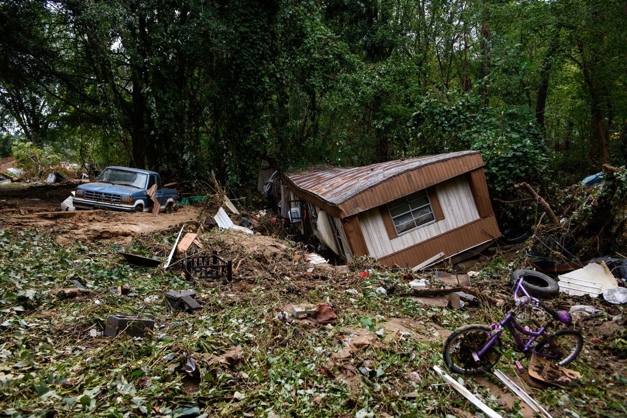 Debris and a mobile home are piled up along a tree line in Old Fort, North Carolina, on Sunday.