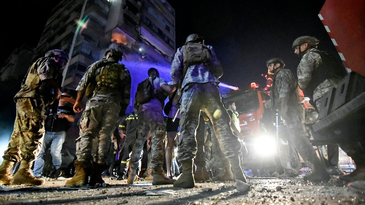 Lebanese army soldiers secure the site outside an apartment building hit by an airstrike in Beirut on Monday.