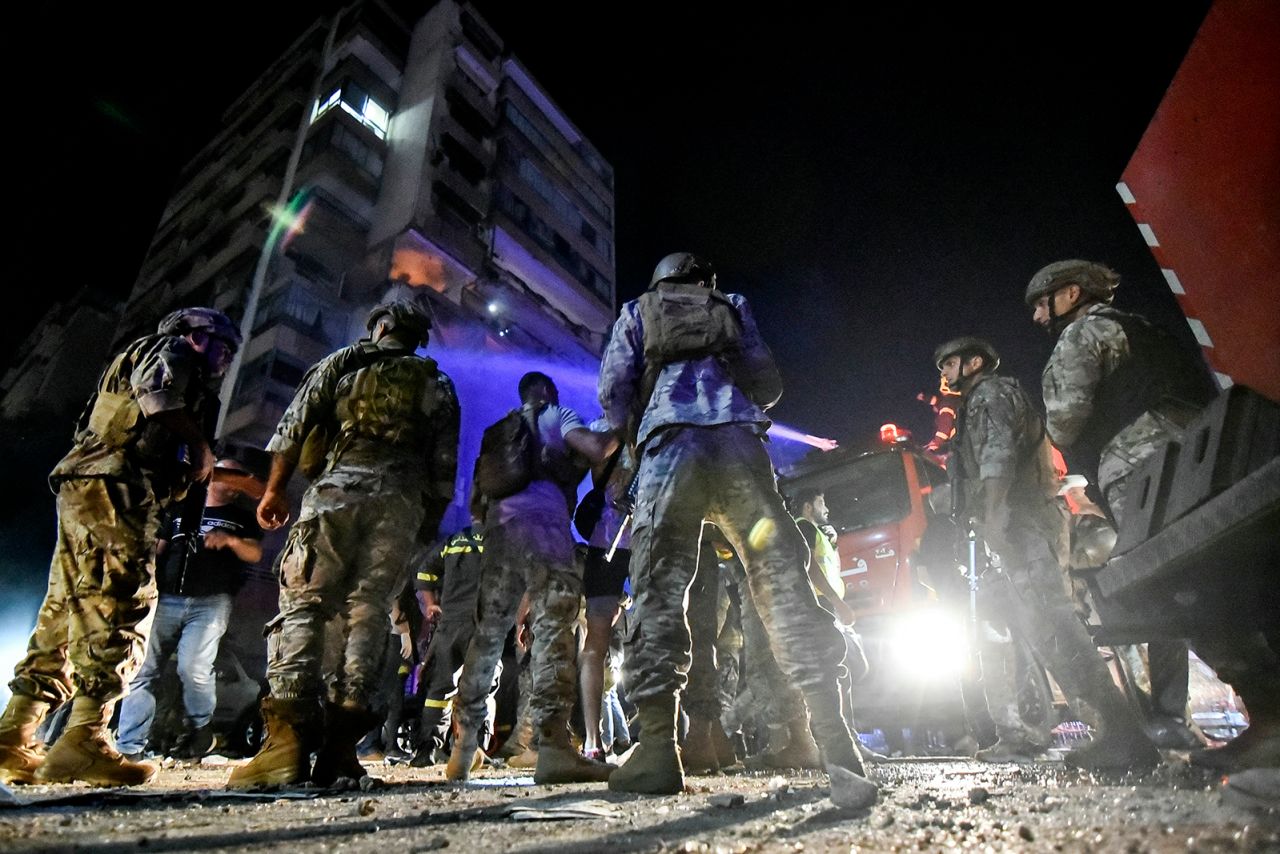 Lebanese army soldiers secure the site outside an apartment building hit by an airstrike in Beirut on Monday.