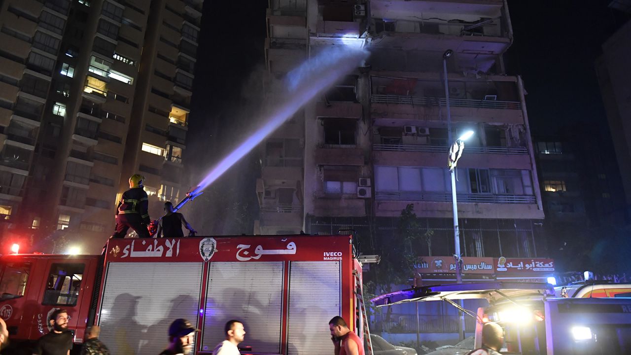 Firefighters extinguish a blaze that broke out in an apartment after an airstrike hit a multi-story building in Beirut, Lebanon's capital, on Monday.