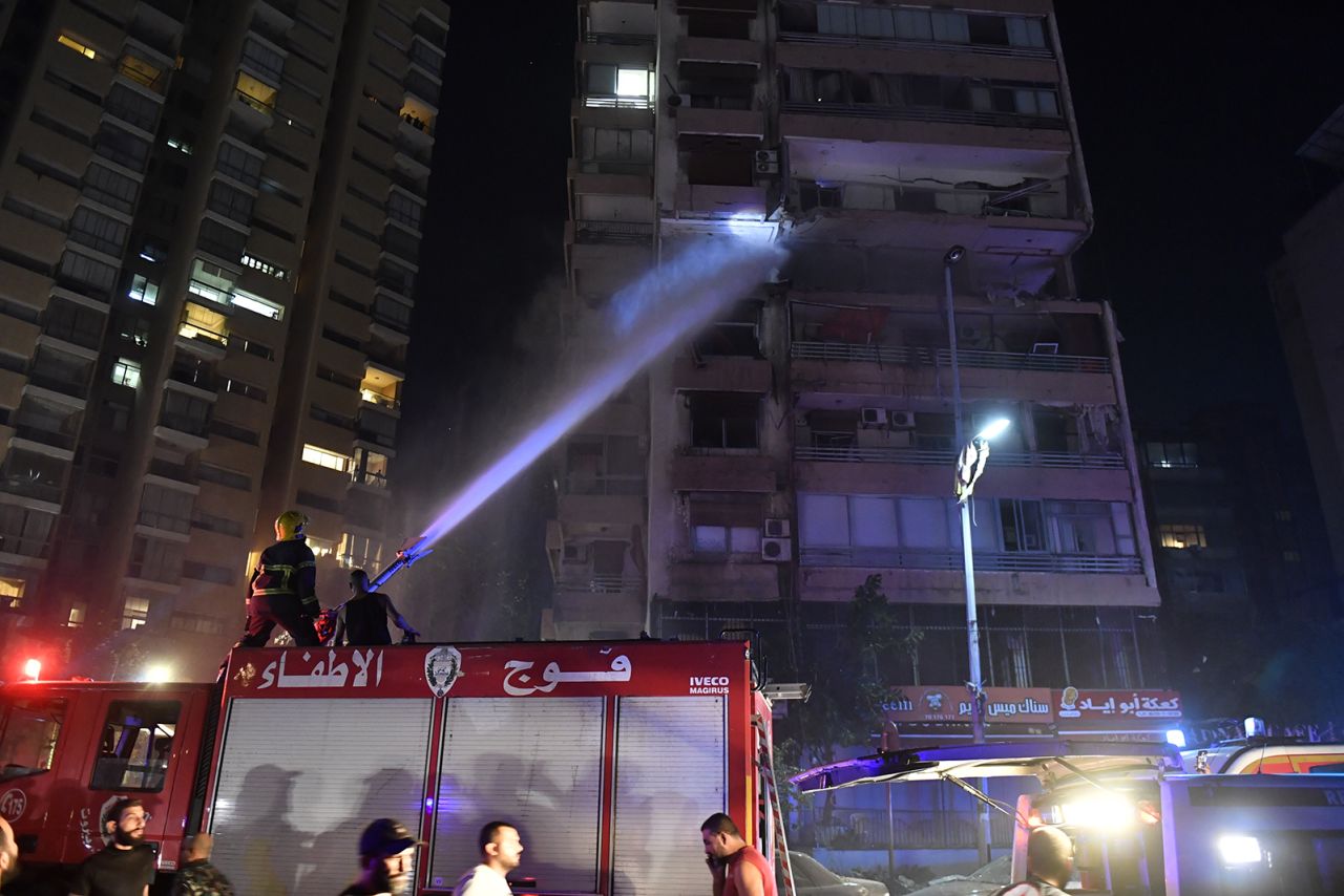 Firefighters extinguish a blaze that broke out in an apartment after an airstrike hit a multi-story building in Beirut, Lebanon's capital, on Monday.