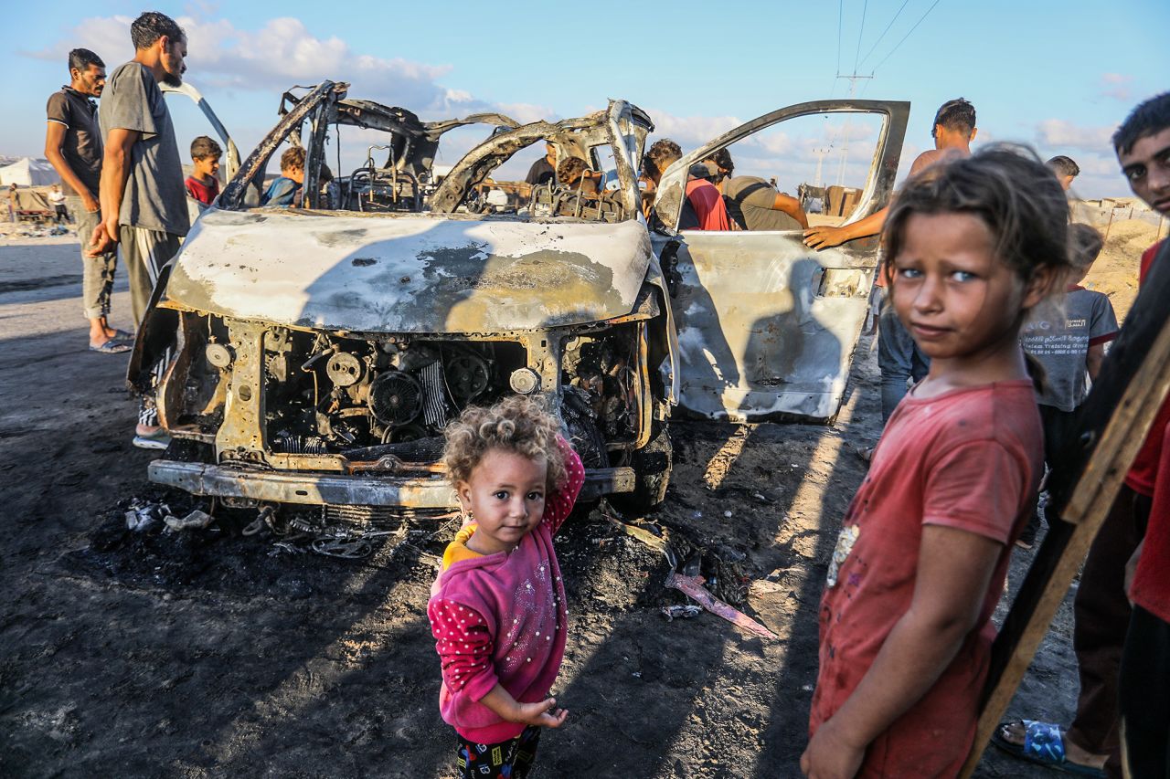 Palestinians inspect a vehicle destroyed following an Israeli attack in Khan Younis, Gaza on September 30.