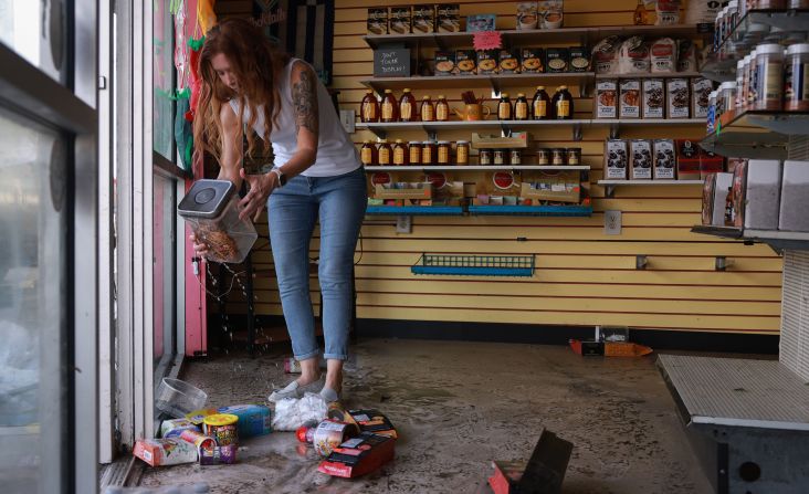 Candace Redwine surveys the damage after about 3 feet of water inundated her Spiceman Kitchen store in Tarpon Springs, Florida, on September 27.