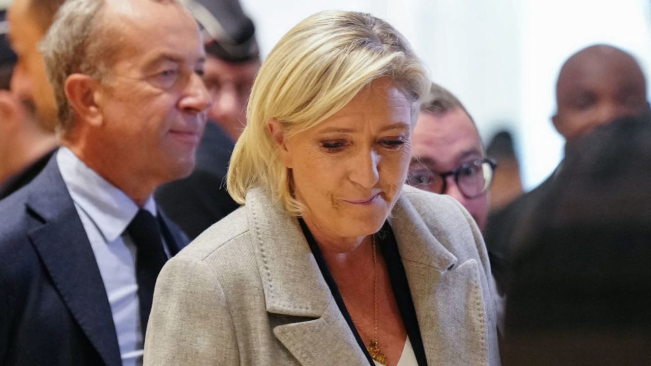 French far-right Rassemblement National (RN) Member of Parliament Marine Le Pen (C) and French lawyer and former MEP Alexandre Varaut (L) arrive at a court house for a trial on suspicion of embezzlement of European public funds, in Paris on September 30, 2024. The trial of Marine Le Pen, 24 other people and the National Rally, suspected of having embezzled funds from the European Parliament to pay party employees, opens on September 30, 2024, before the Paris criminal court, a case with serious political stakes for the leader of the far right. (Photo by Dimitar DILKOFF / AFP) (Photo by DIMITAR DILKOFF/AFP via Getty Images)