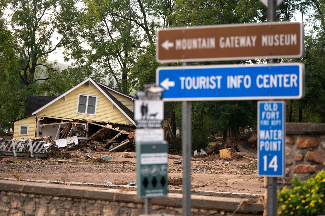 A storm-damaged home lies in ruins in Old Fort, North Carolina, near a tourist information sign. (Photo by Sean Rayford/Getty Images)