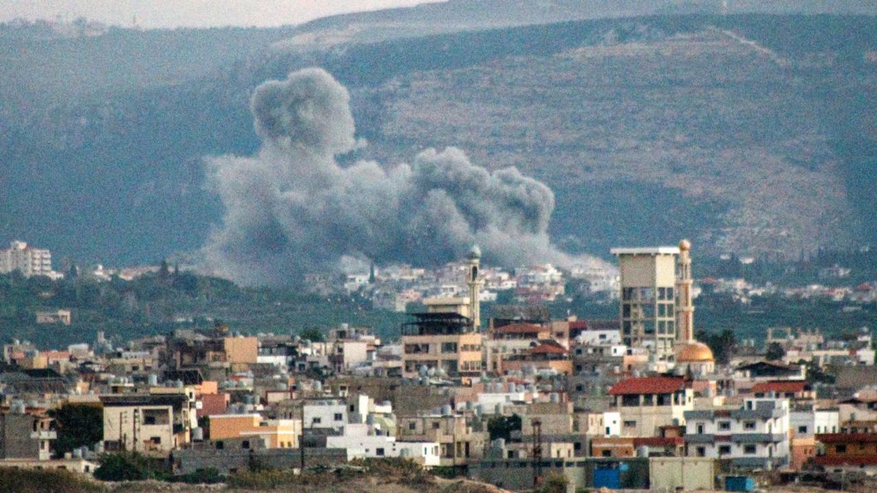 This overview from Lebanon's southern city of Tyre shows a cloud of smoke erupting after an Israeli air strike on the village of Qlayleh on September 30, 2024. (Photo by Kawnat HAJU / AFP) (Photo by KAWNAT HAJU/AFP via Getty Images)