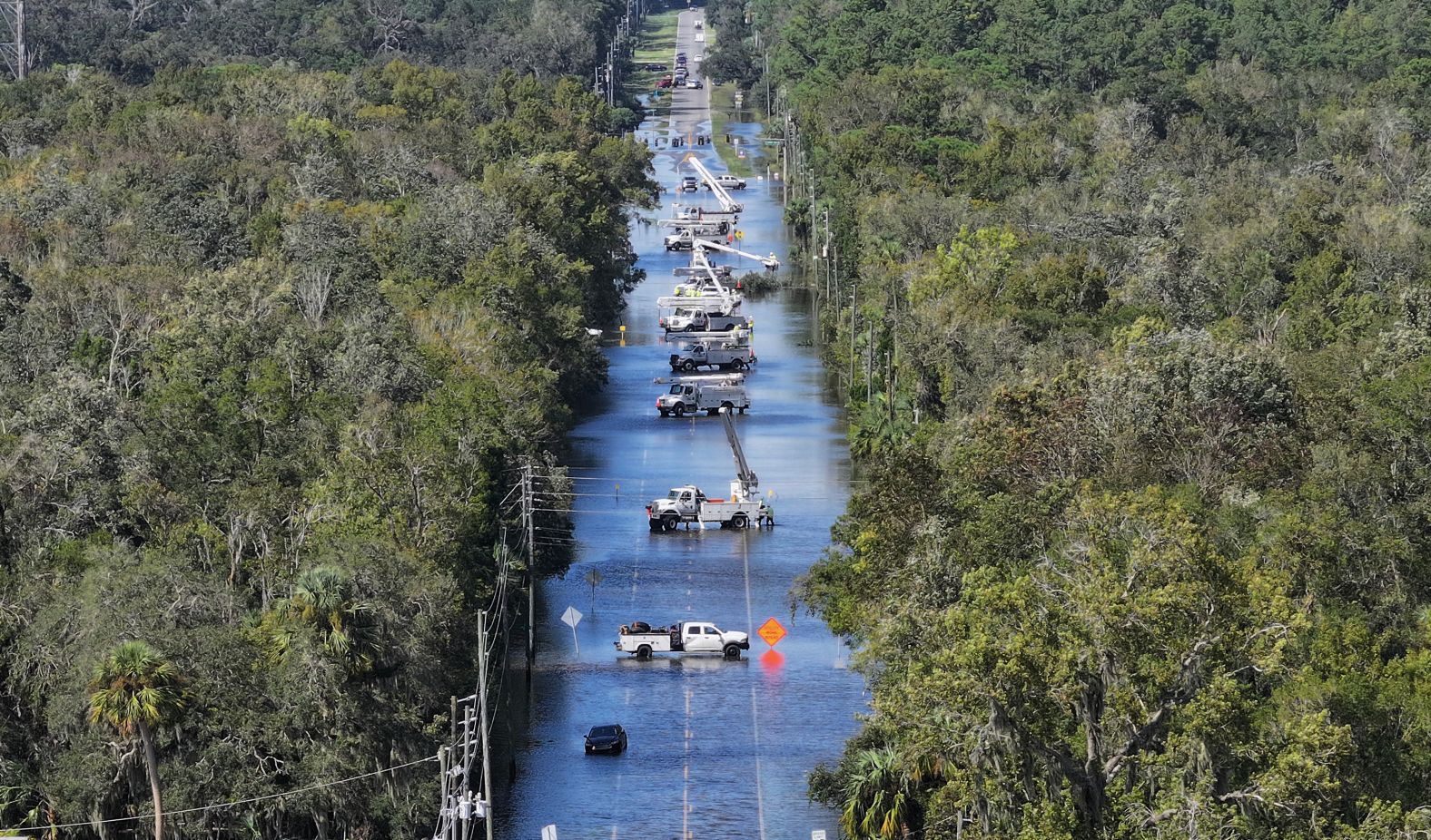 People work on power lines after Hurricane Helene passed offshore in Crystal River, Florida, on Friday.