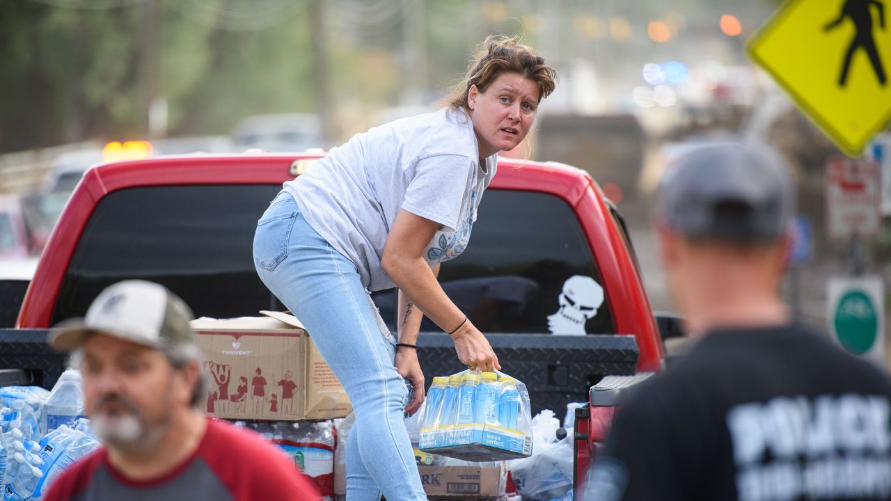 Ashley Dillinger donates water at the Town Hall in Old Fort, North Carolina, on Monday, September 30, 2024.